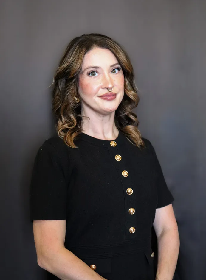 Studio portrait of a woman in a black button dress