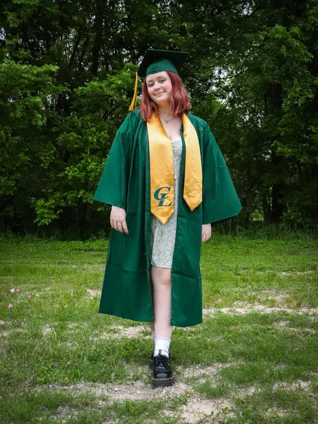 Graduate in a green cap and gown
